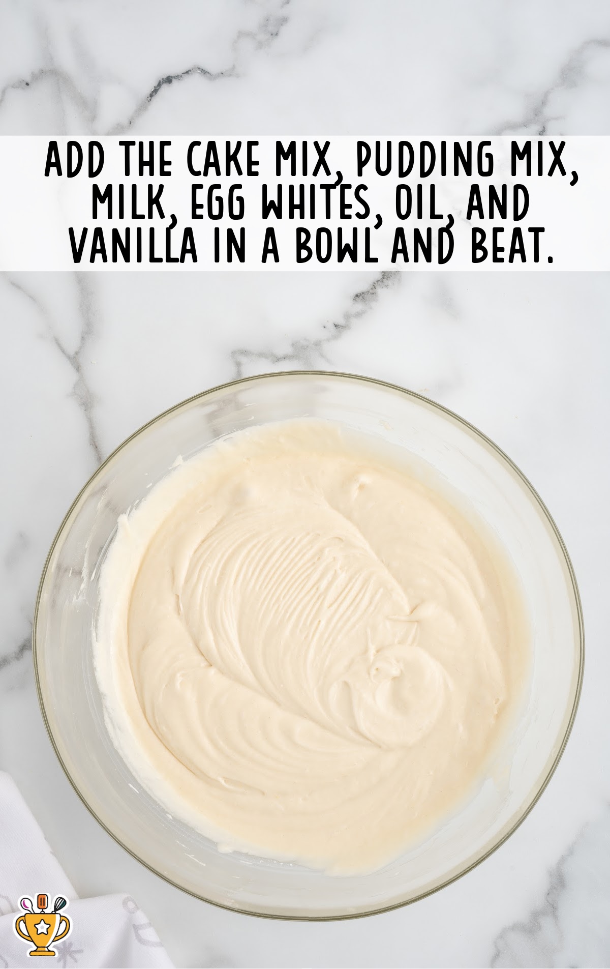 a mixture of cake mix, pudding mix, milk, egg whites, oil, and vanilla in a bowl