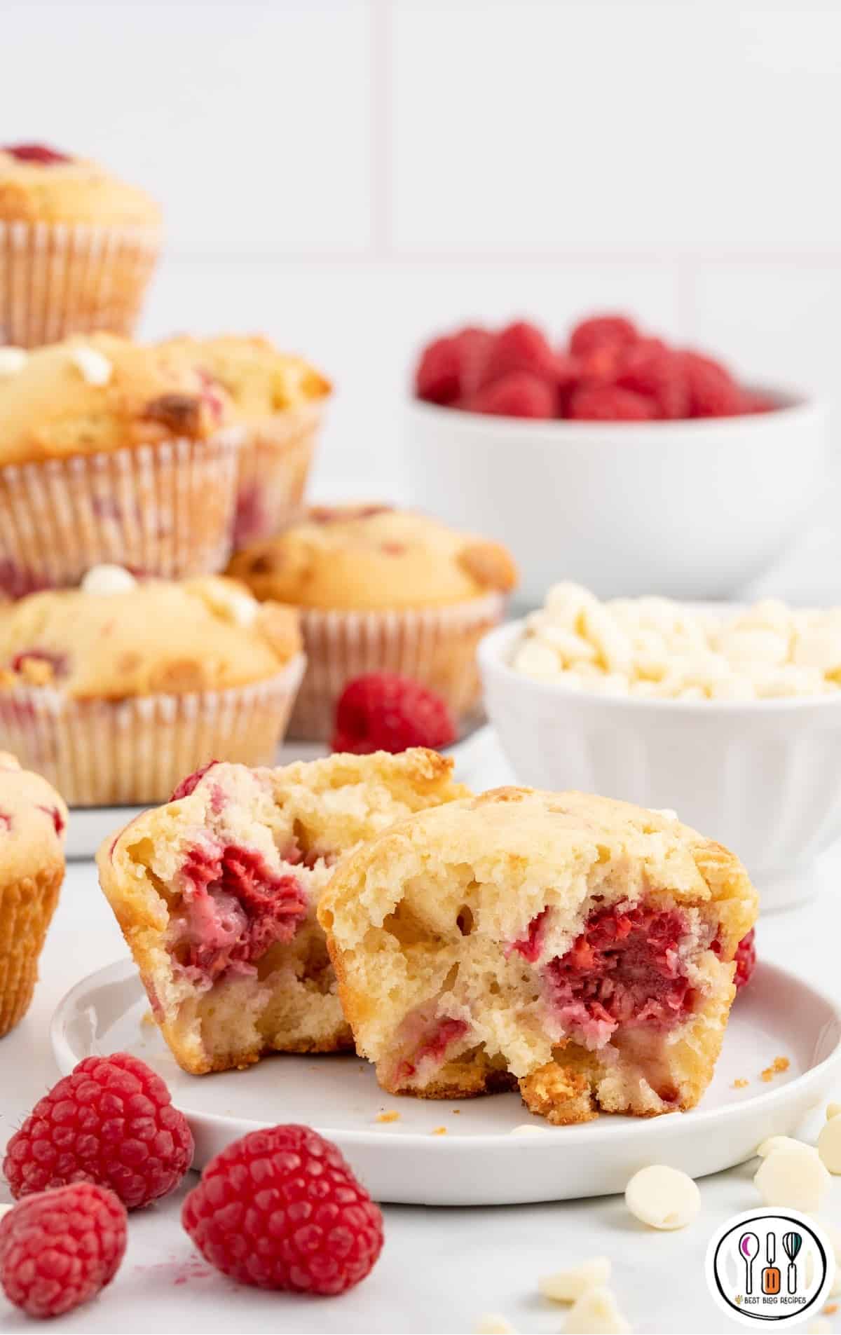 A broken open muffin on a white plate.