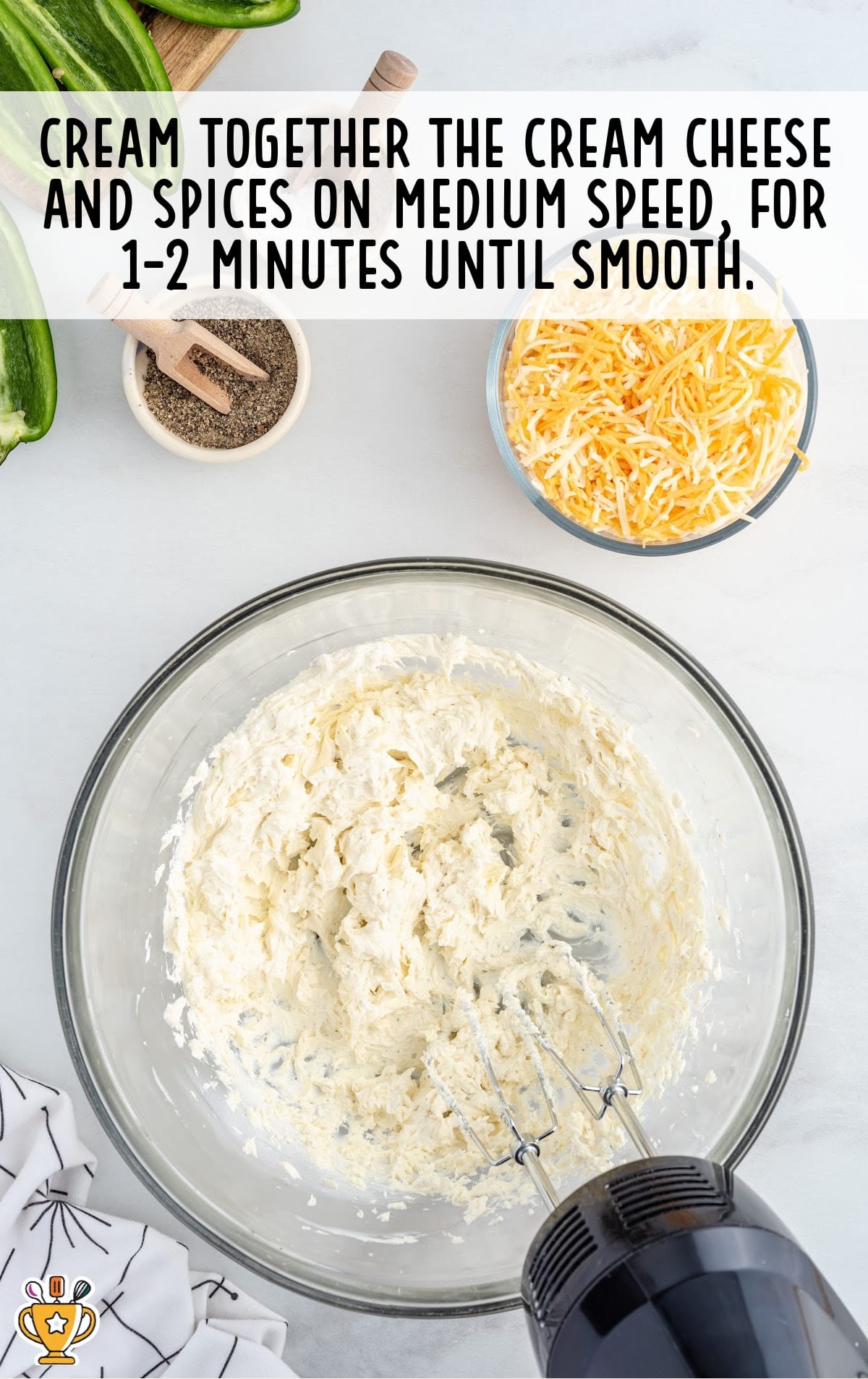 The cream cheese and spices are blended together in a mixing bowl.