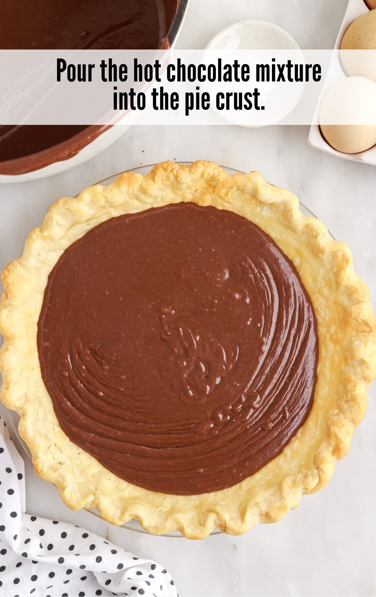 pouring hot chocolate mixture into the pie crust