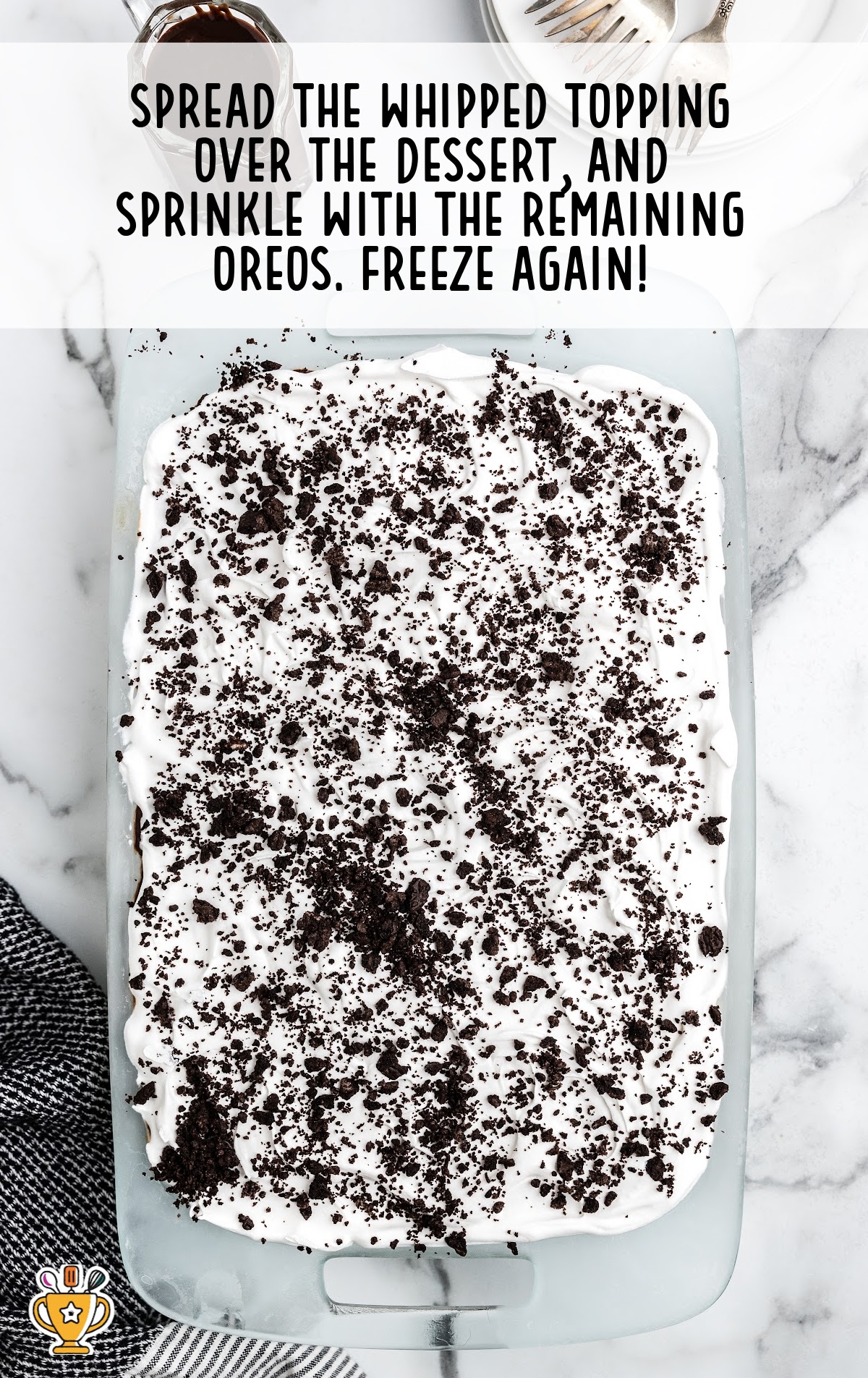Cool whip and crushed oreos decorate the top of the cake.