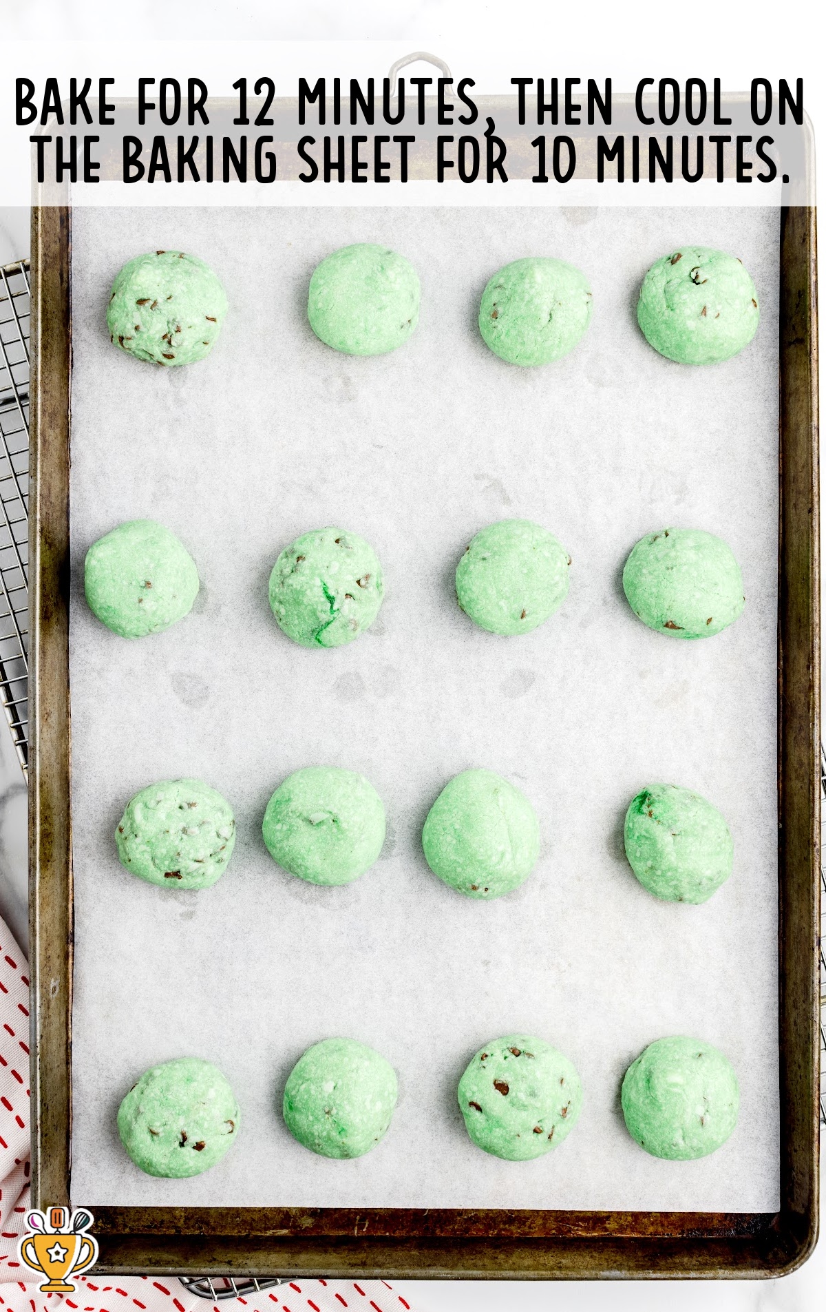 baked Grinch Snowball Cookies on a baking tin