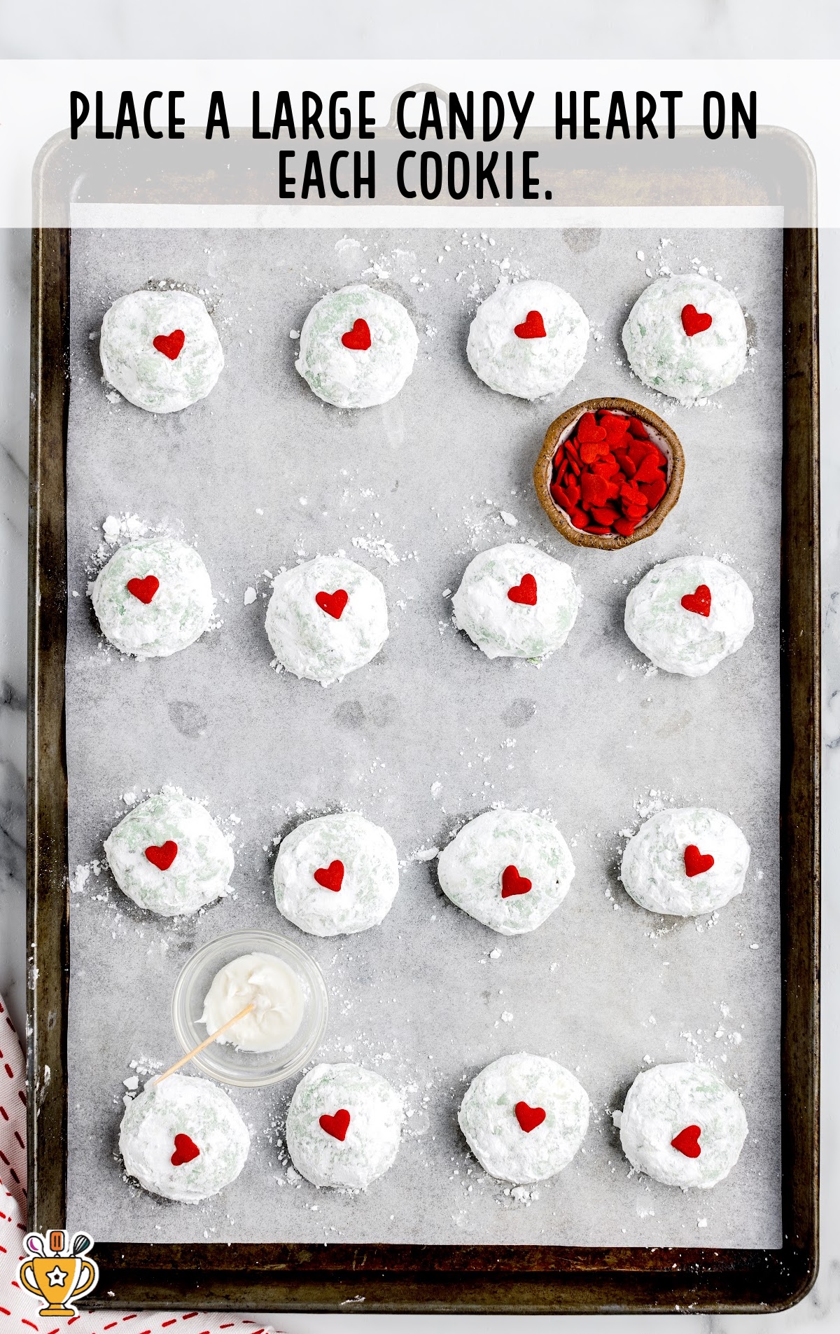 Grinch Snowball Cookies on a baking tin