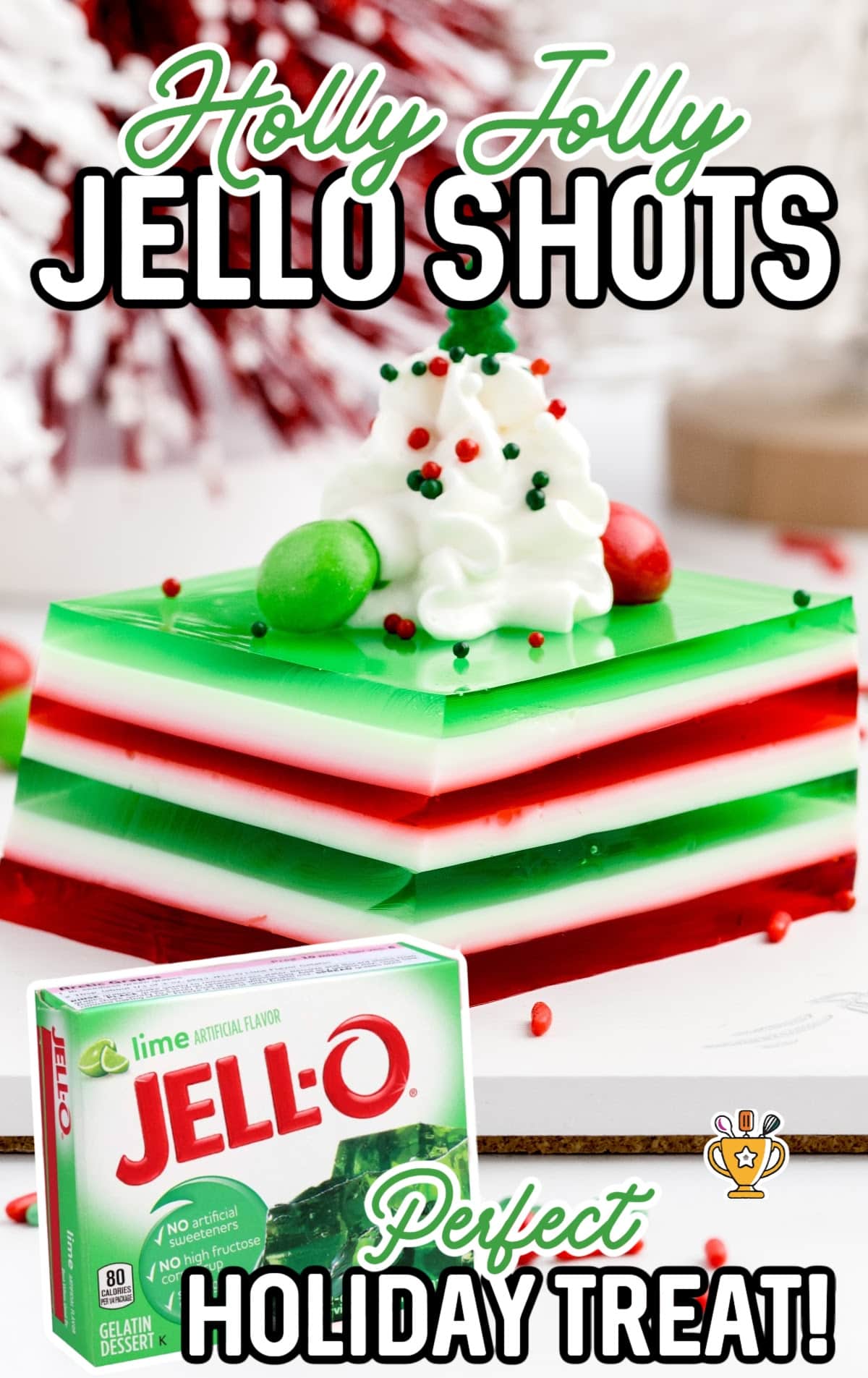 A box of jello beside a slice of prepared Holly Jolly Jello Shots.