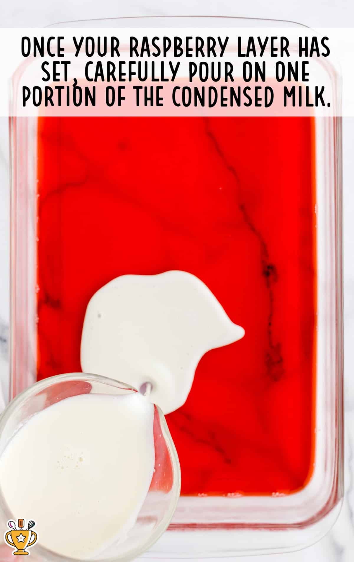 slowly pour the sweetened condensed milk over the jello layer.