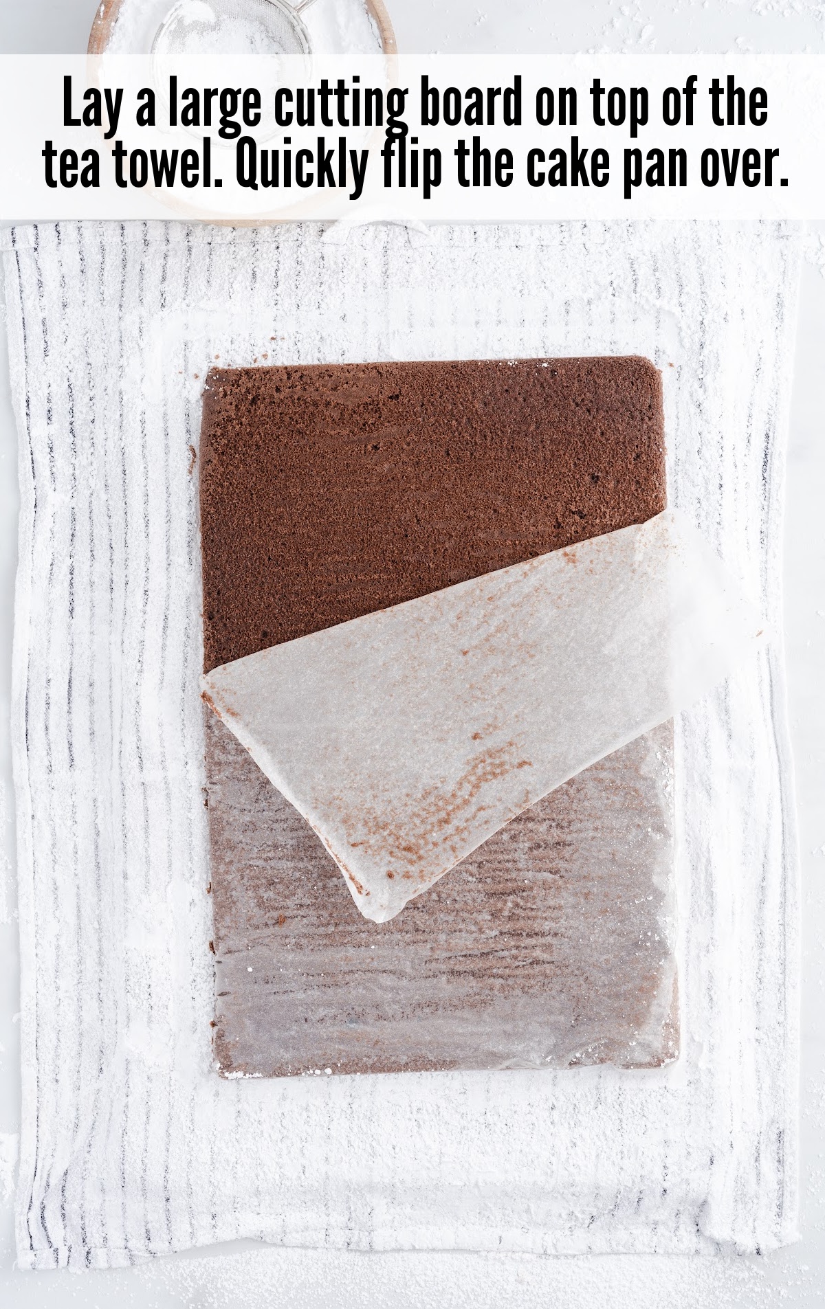 laying a cutting board on top of the tea towel and flipping the cake pan over
