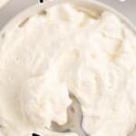 Mascarpone Frosting in a serving bowl with a spoon in it