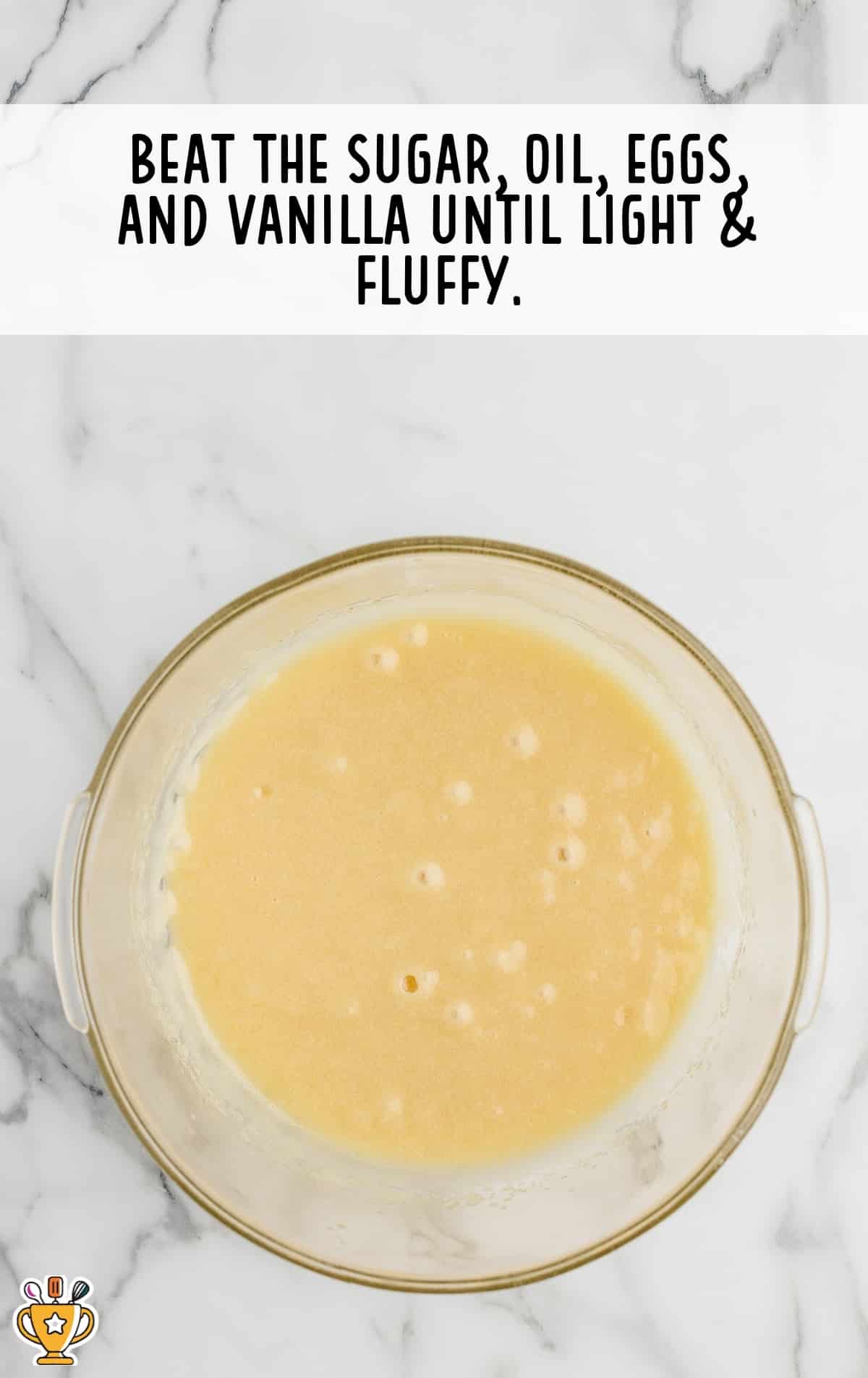 sugar, oil, eggs and vanilla mixed in a bowl