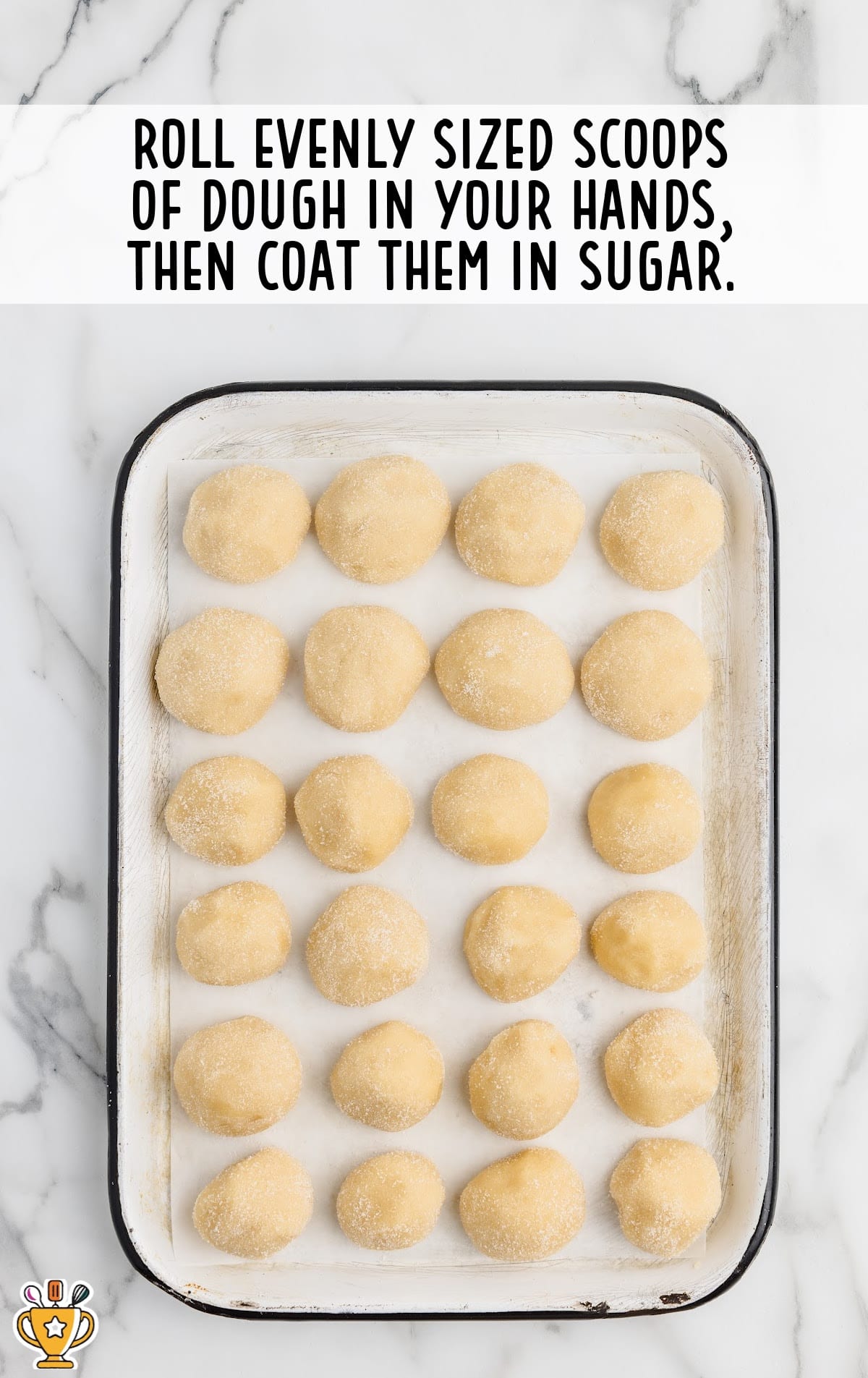 scoops of dough coated in sugar on a baking pan