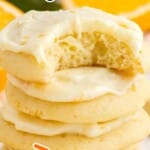 A stack of Orange Cookies, the top one with a bite on it
