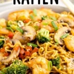 A dinner plate of shrimp with ramen.