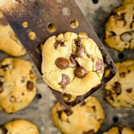 a spatula holding a Air Fryer Chocolate Chip Cookie and others in a air fryer