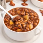 Apple Pie Baked Beans in a bowl with a spoon in it