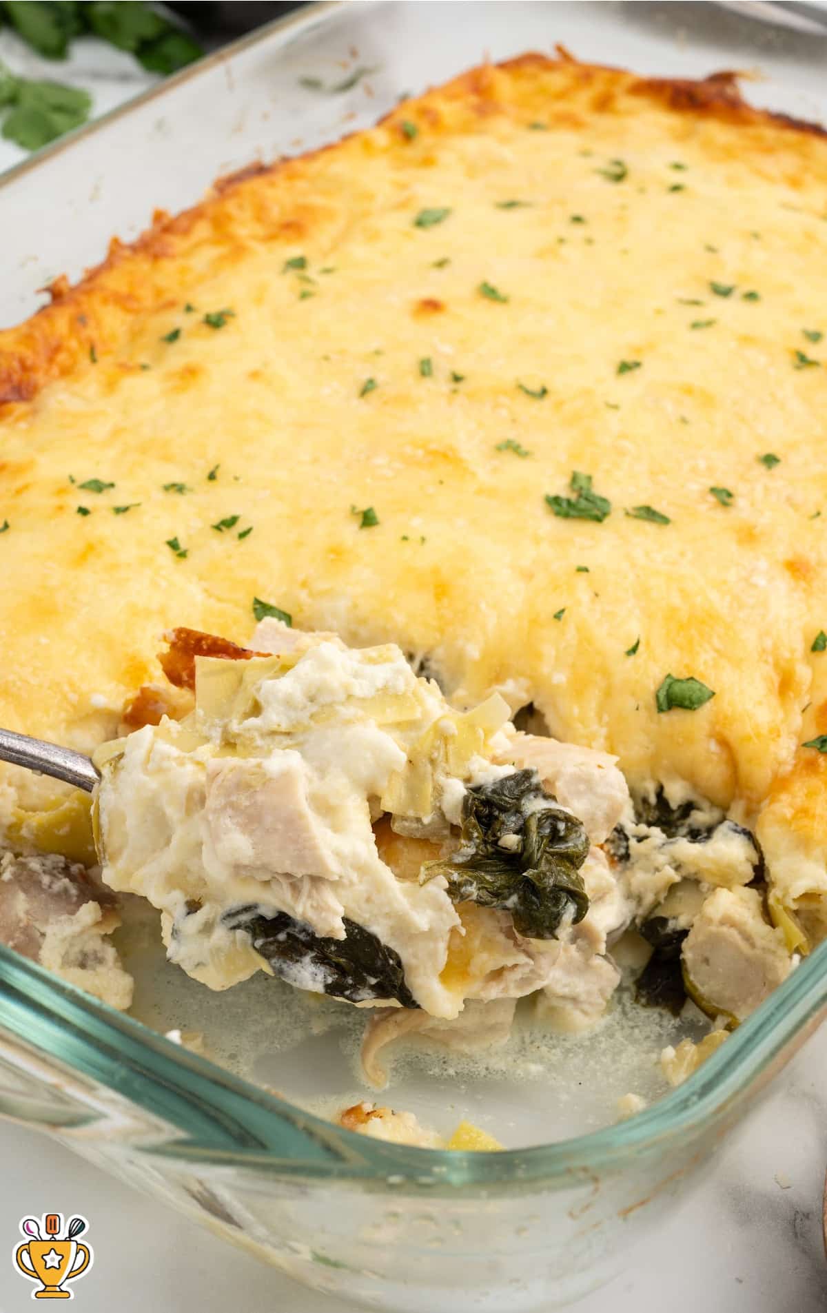 Spinach and Artichoke Chicken Casserole in a clear baking dish