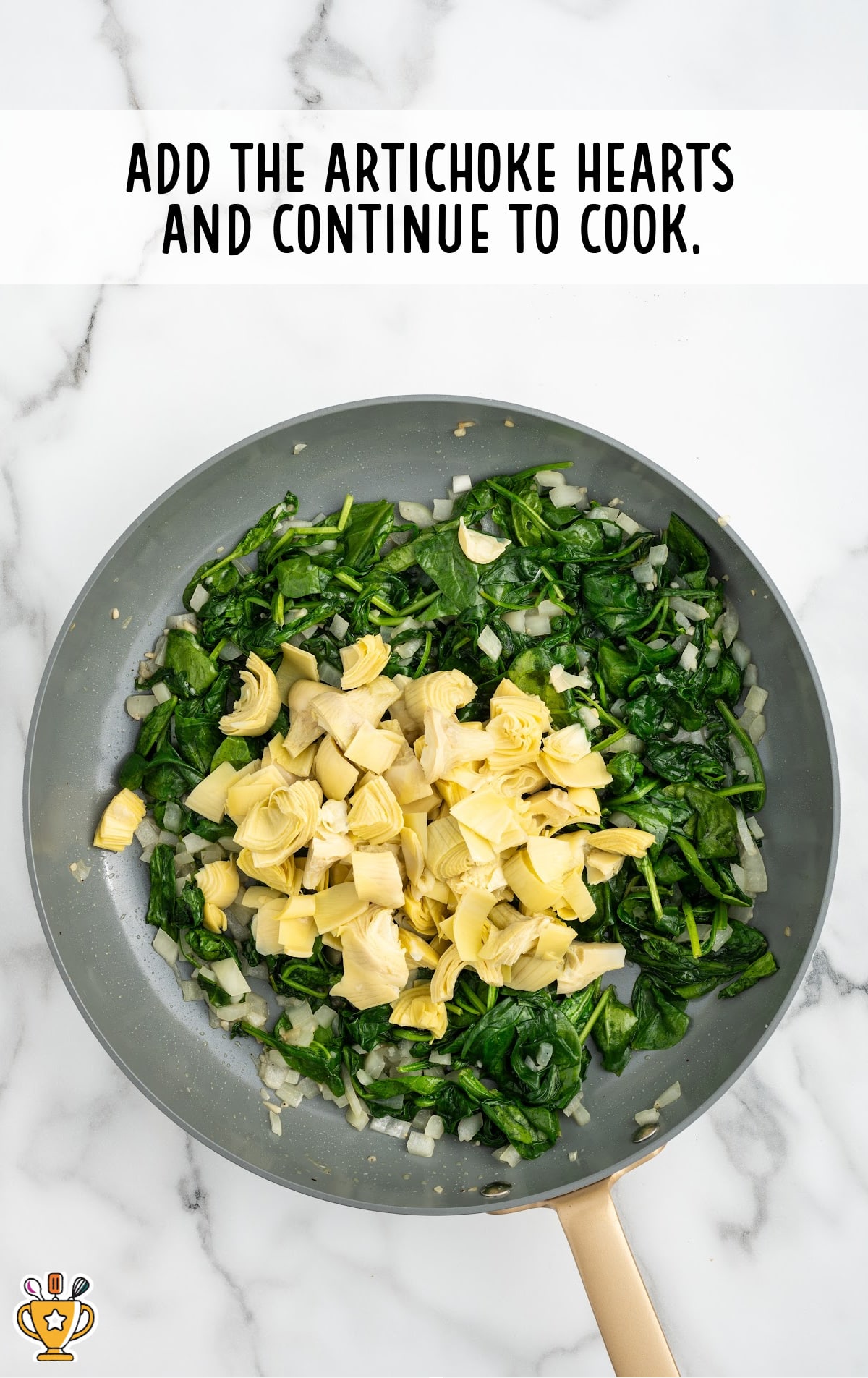 artichoke hearts added in a skillet of spinach