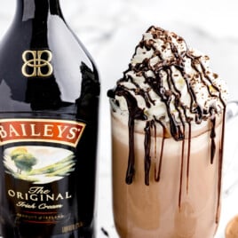 Baileys Hot Chocolate in a mug with a bottle of baileys