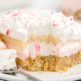 a piece of Candy Cane Dessert on a plate with a fork