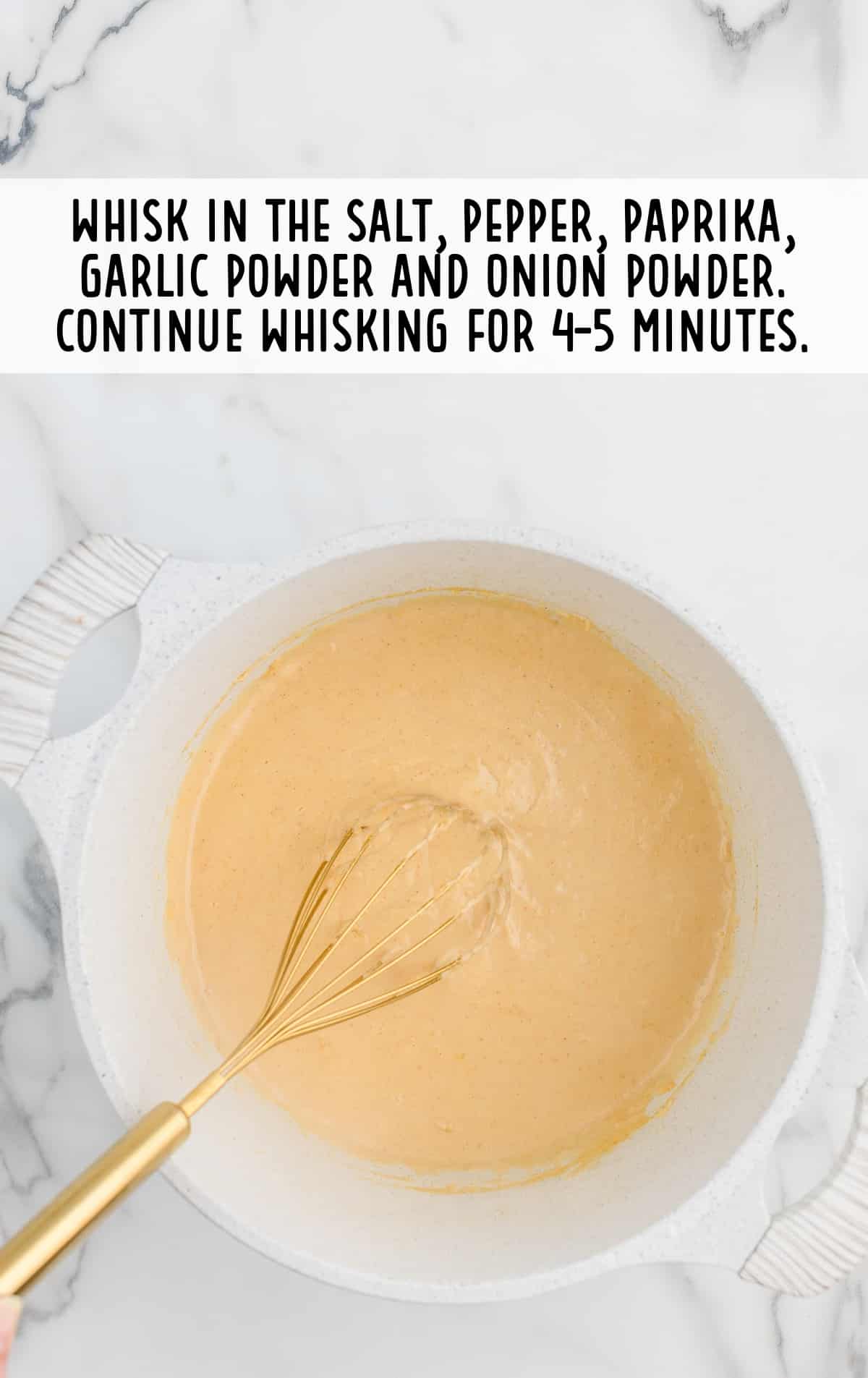 a whisk in a bowl of ingredients for making Copycat Chick Fil A Macaroni and Cheese