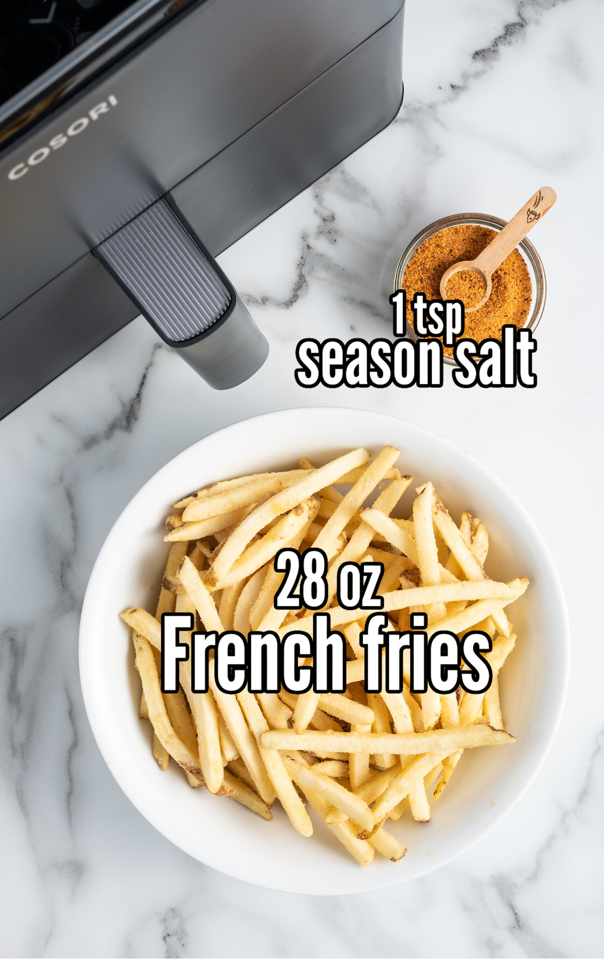 Air Fryer Frozen French Fries in a bowl with a bowl of season salt on the side
