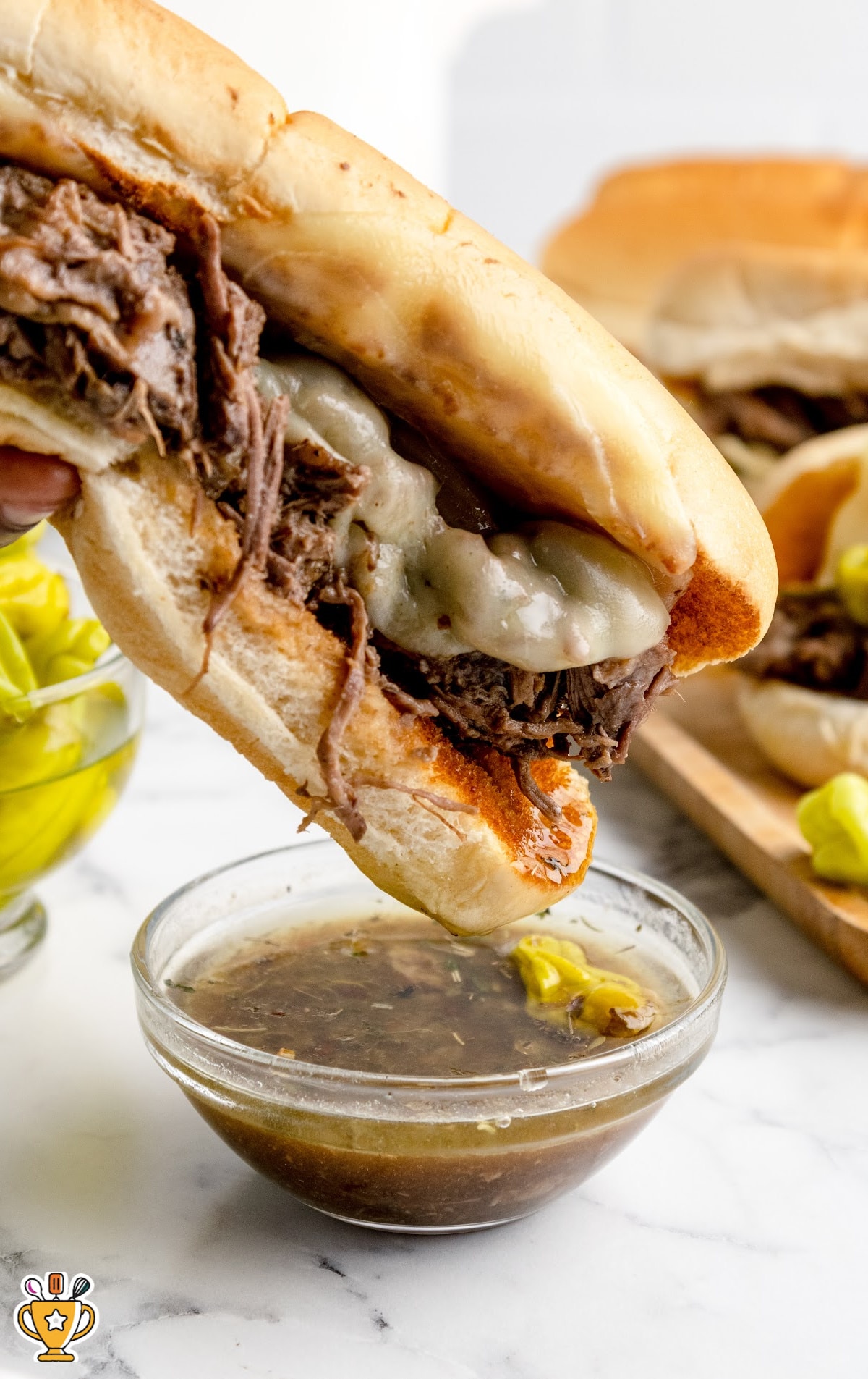 Italian Beef Sandwich dipped in a bowl of soup