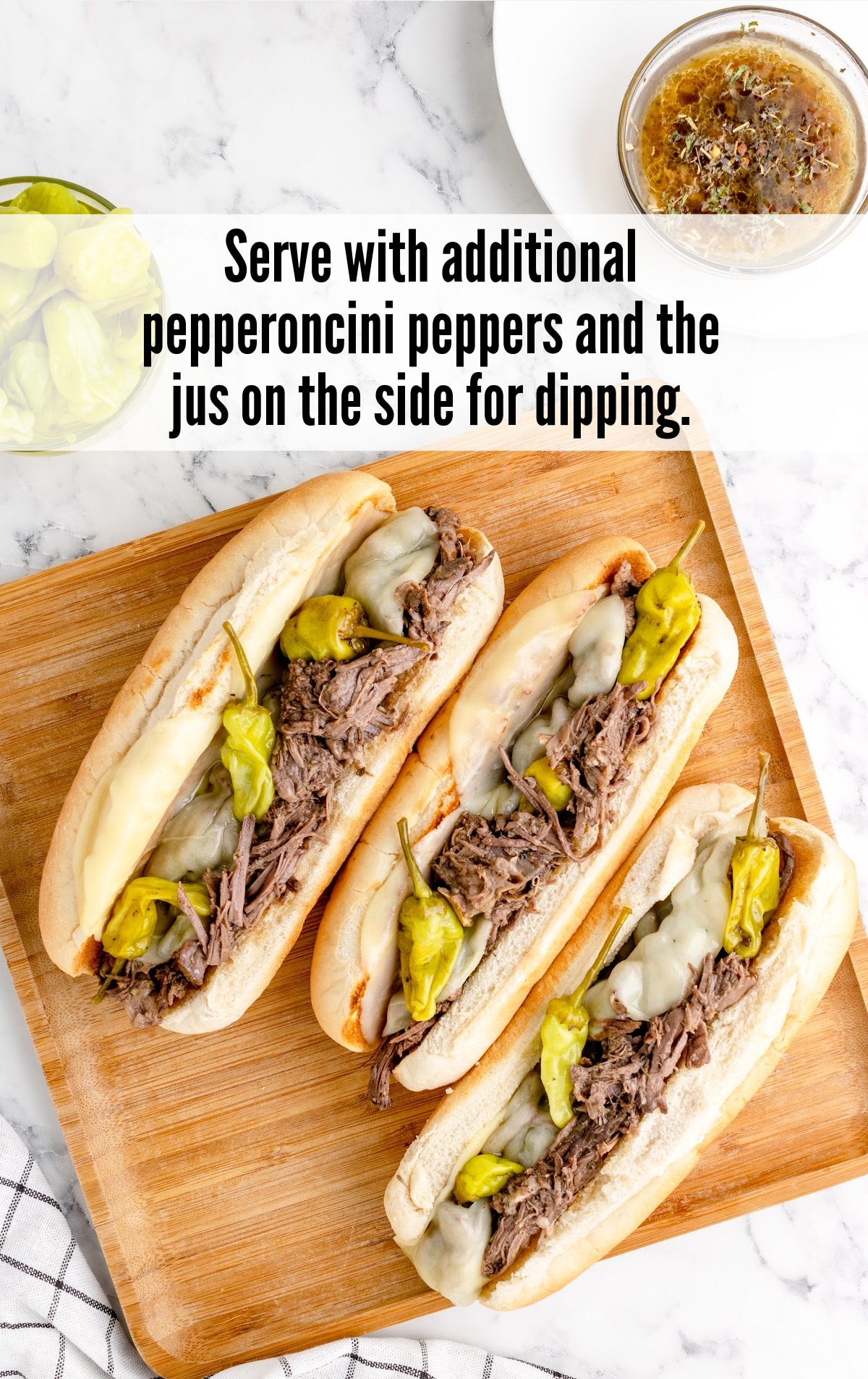 three Italian Beef Sandwich on a wooden plate