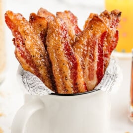 Million Dollar Bacon in a mug with maple syrup in a mug