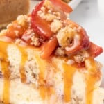 Vertical pin image showing a caramel-drizzled slice of peach cobbler cheesecake topped with tender peaches and crumble, with a smaller image of the whole cheesecake at the bottom and bold recipe text overlaid.