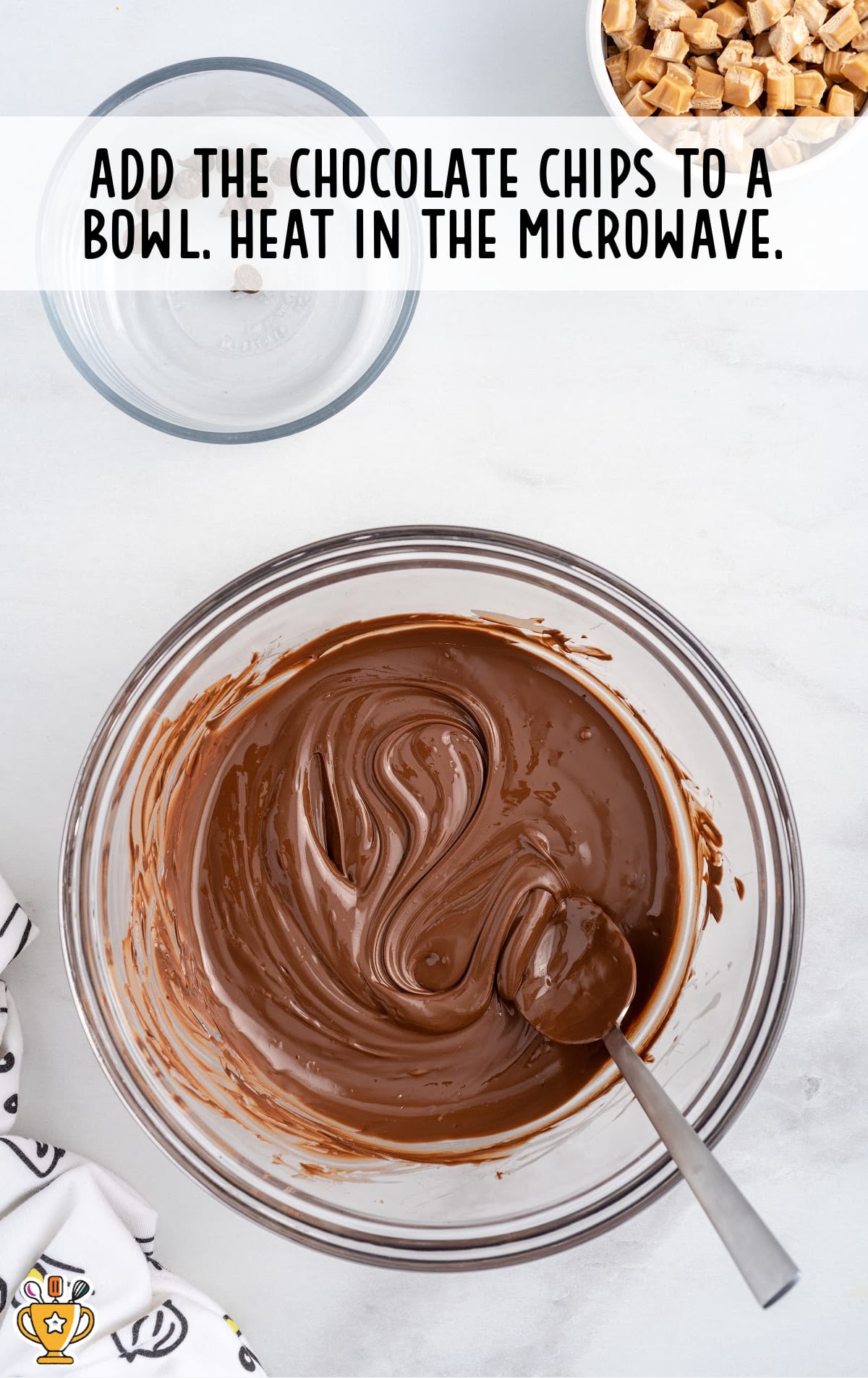melted chocolate in a bowl with a spoon in it