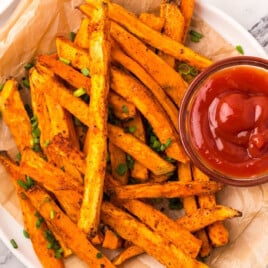 Sweet Potato Fries on a plate and a bowl of sauce on it