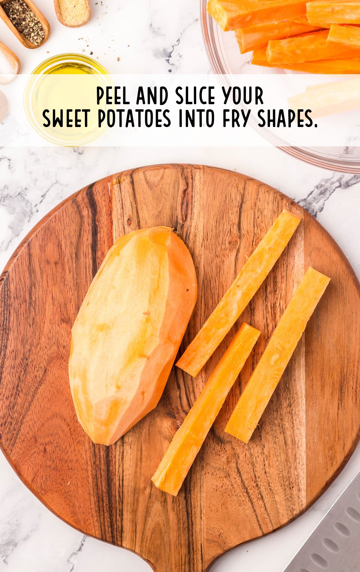 potato peeled and sliced into fry shapes on a wooden board