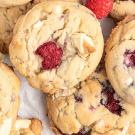 An overhead photo of White Chocolate and Raspberry Cookies on parchment.