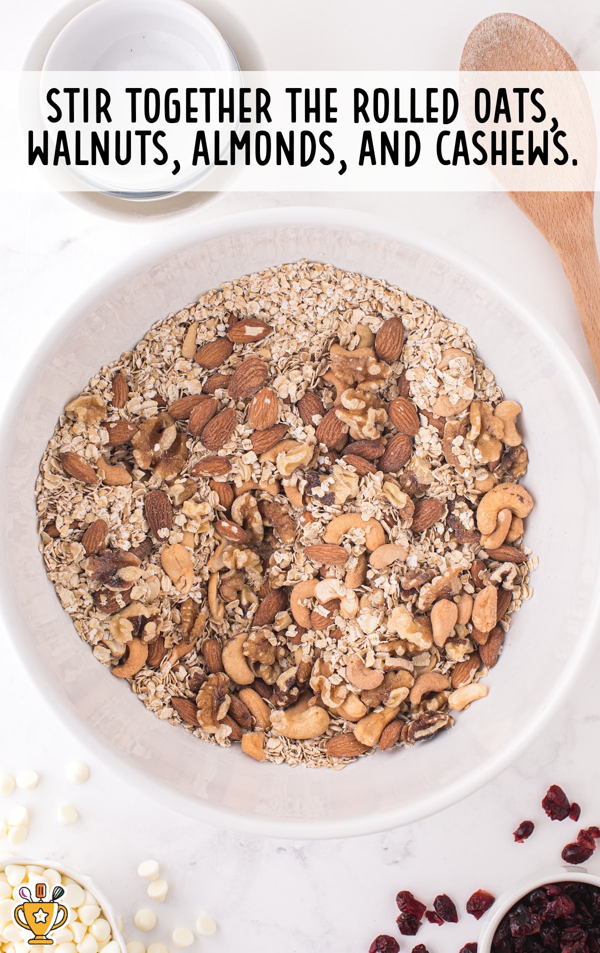 rolled oats, walnuts, almonds and cashews mixed in a bowl