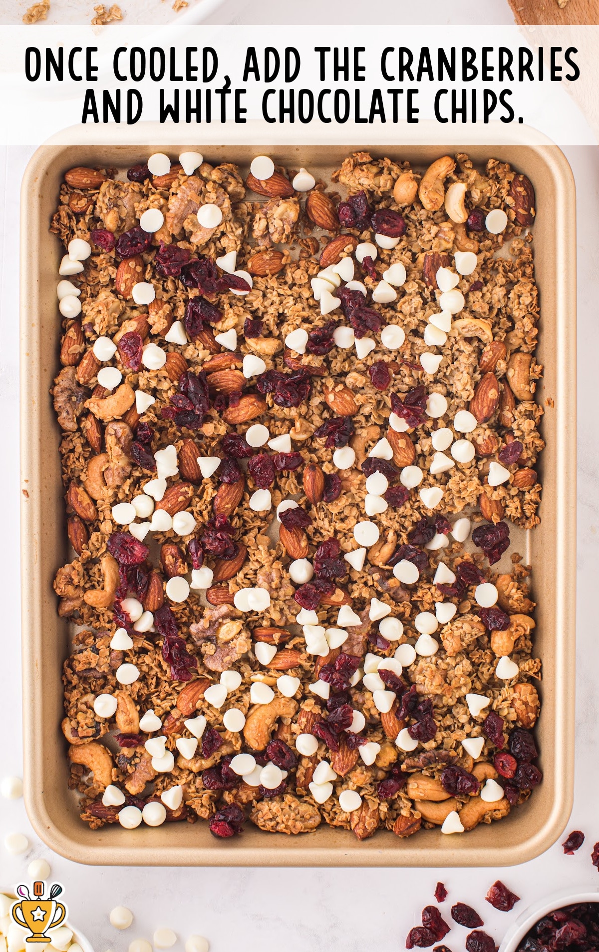 Christmas Granola in a baking tin with added cranberries and white chocolate chips