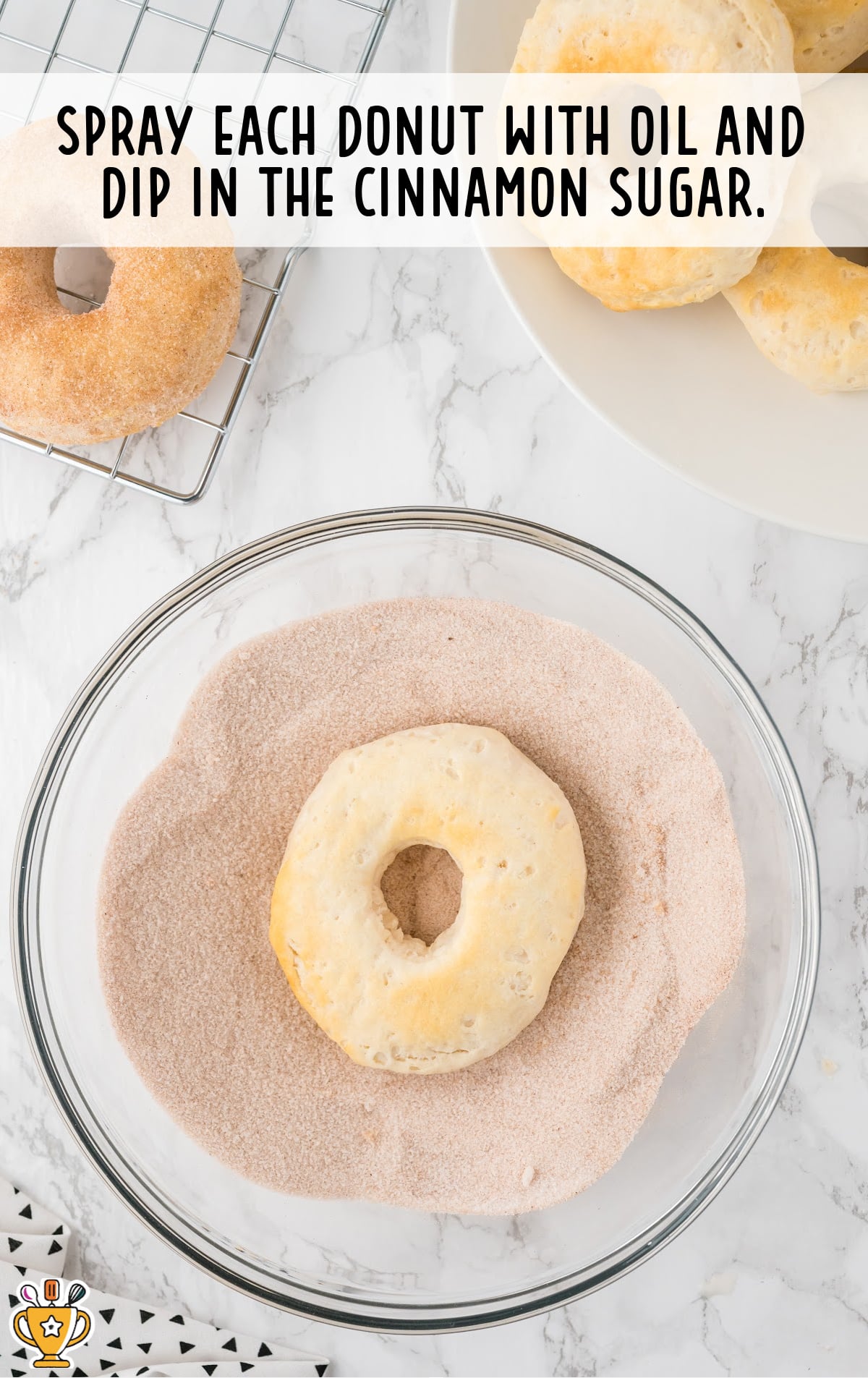 an Air Fryer Donut sprayed with oil and dipped in the cinnamon sugar