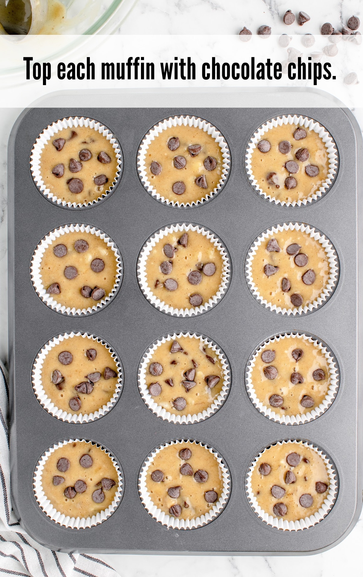 muffins toped with chocolate chips in a pan