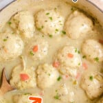 Chicken and Dumplings in a pot with a wooden spoon