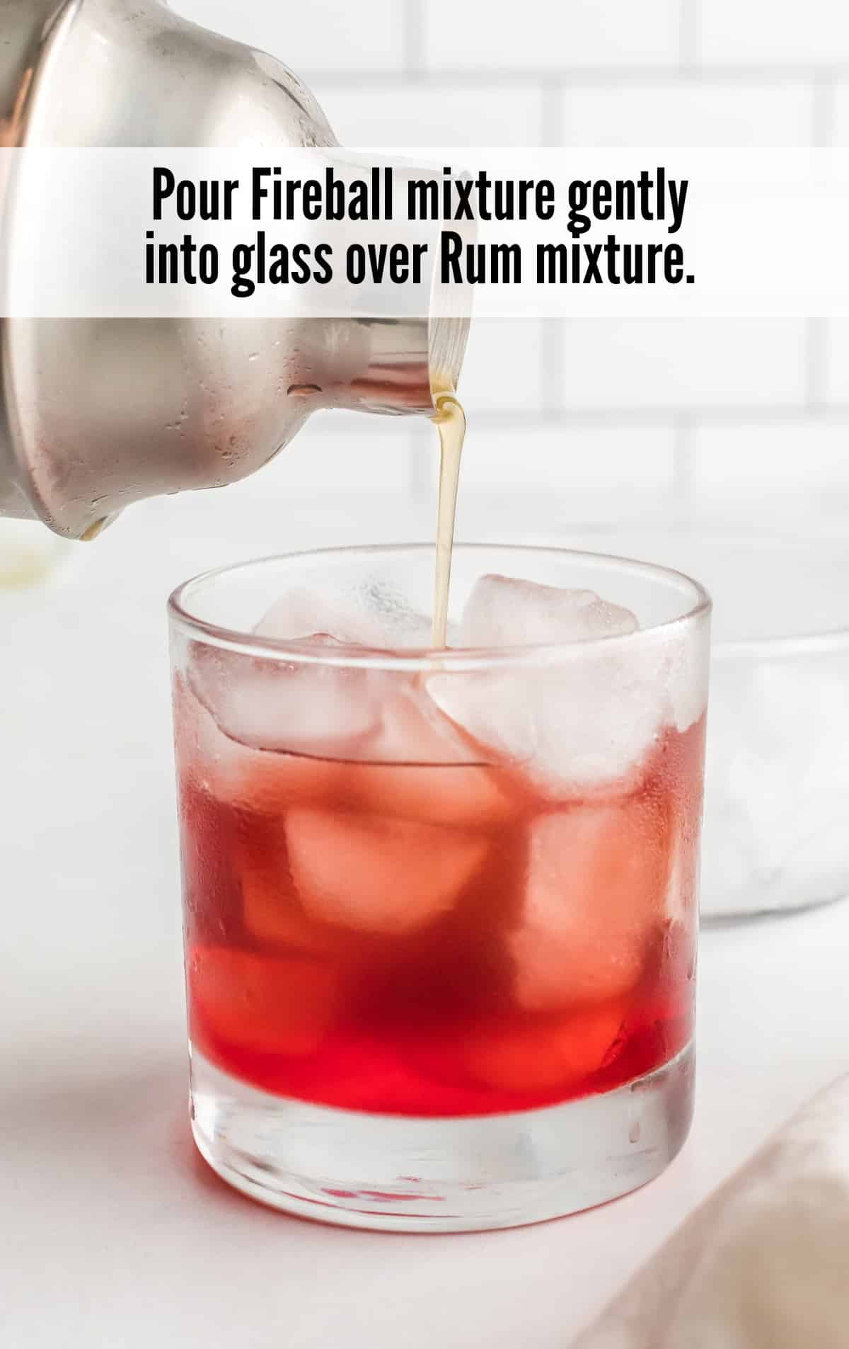 fireball mixture poured into a glass over rum mixture