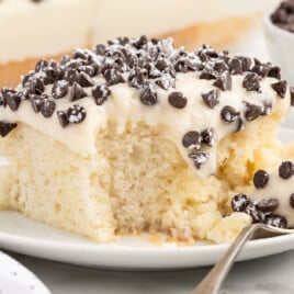 a piece of Cannoli Poke Cake on a plate