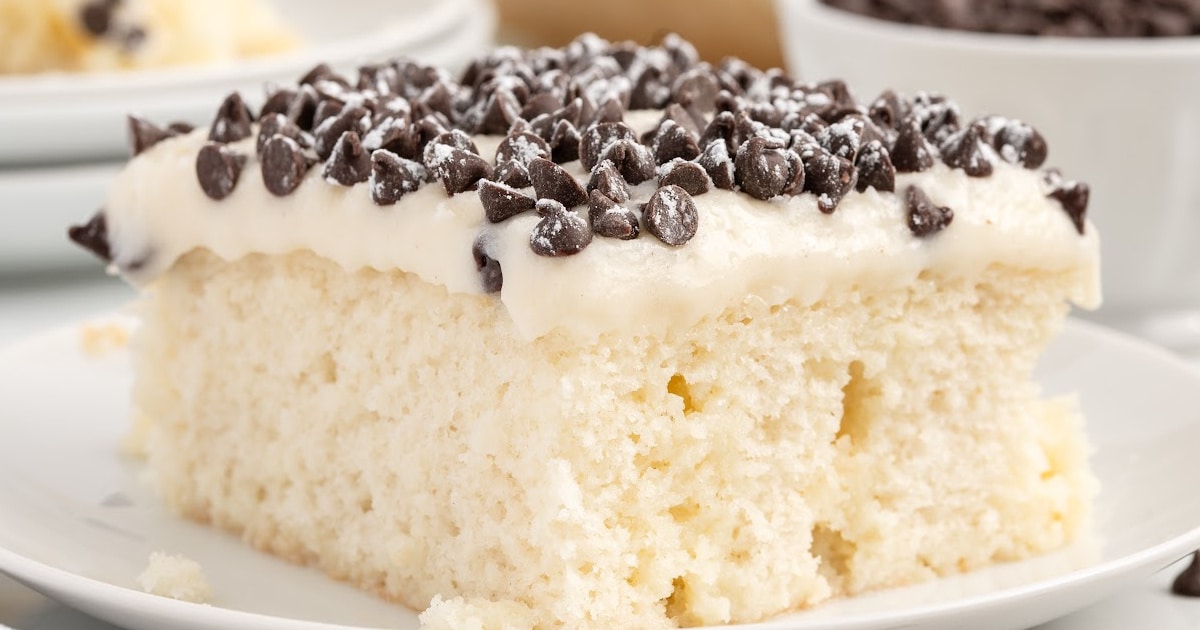 a piece of Cannoli Poke Cake on a plate