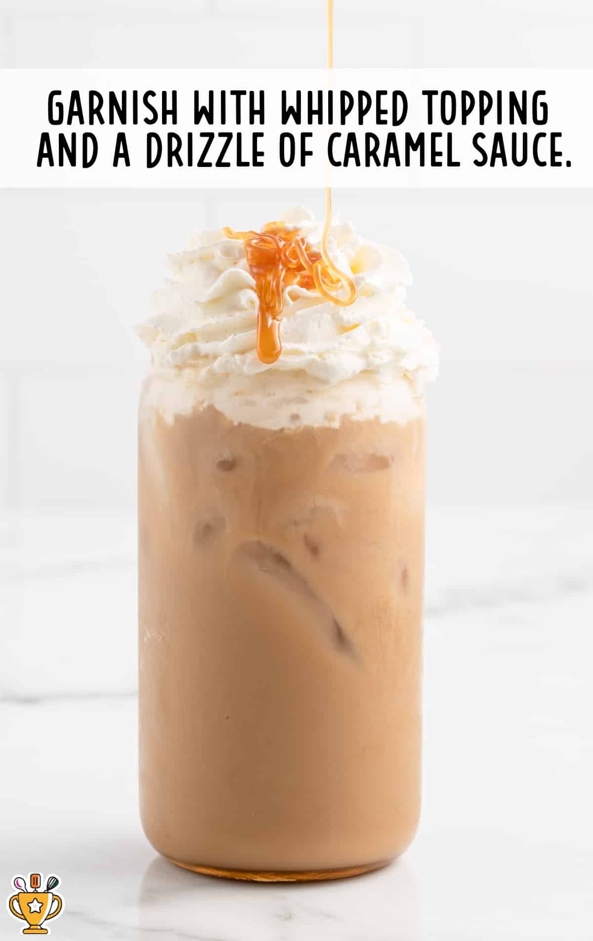garnishing with whipped topping and a drizzle of caramel sauce