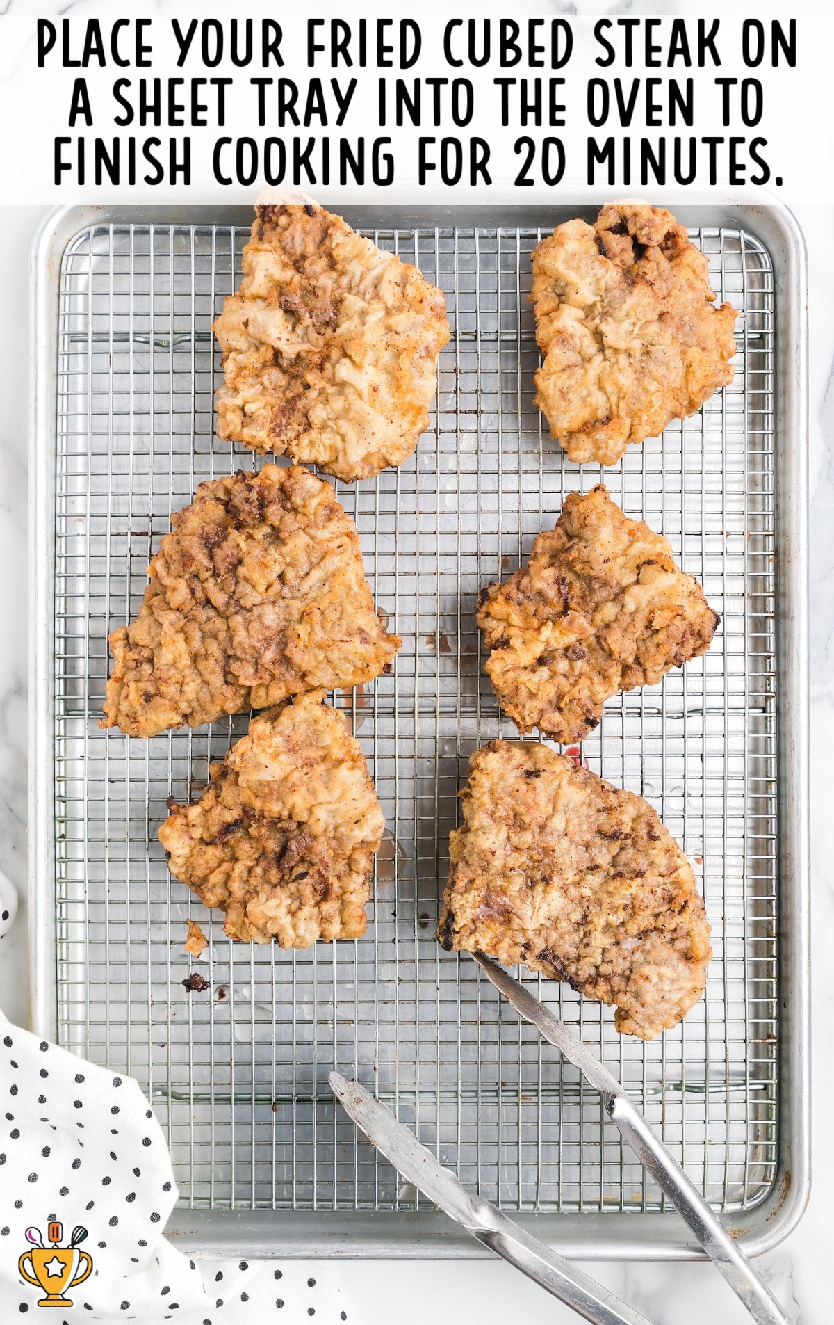fried cube steak placed on a sheet tray