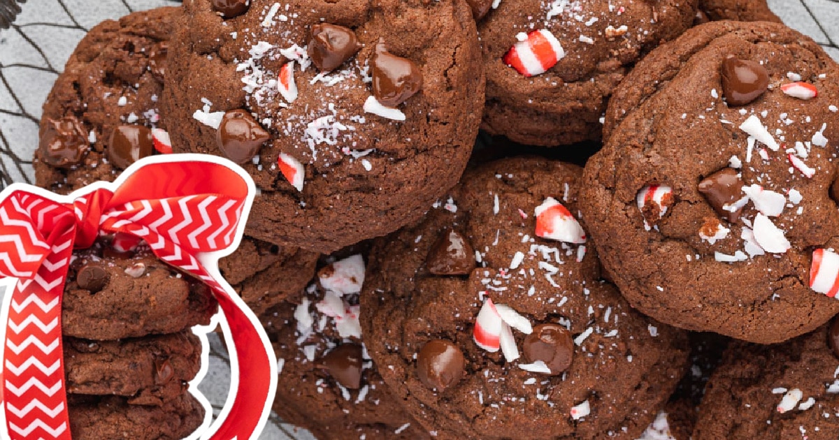 Chocolate peppermint cookies in a basket and another stack of cookies is tied with a bow like a presetn.