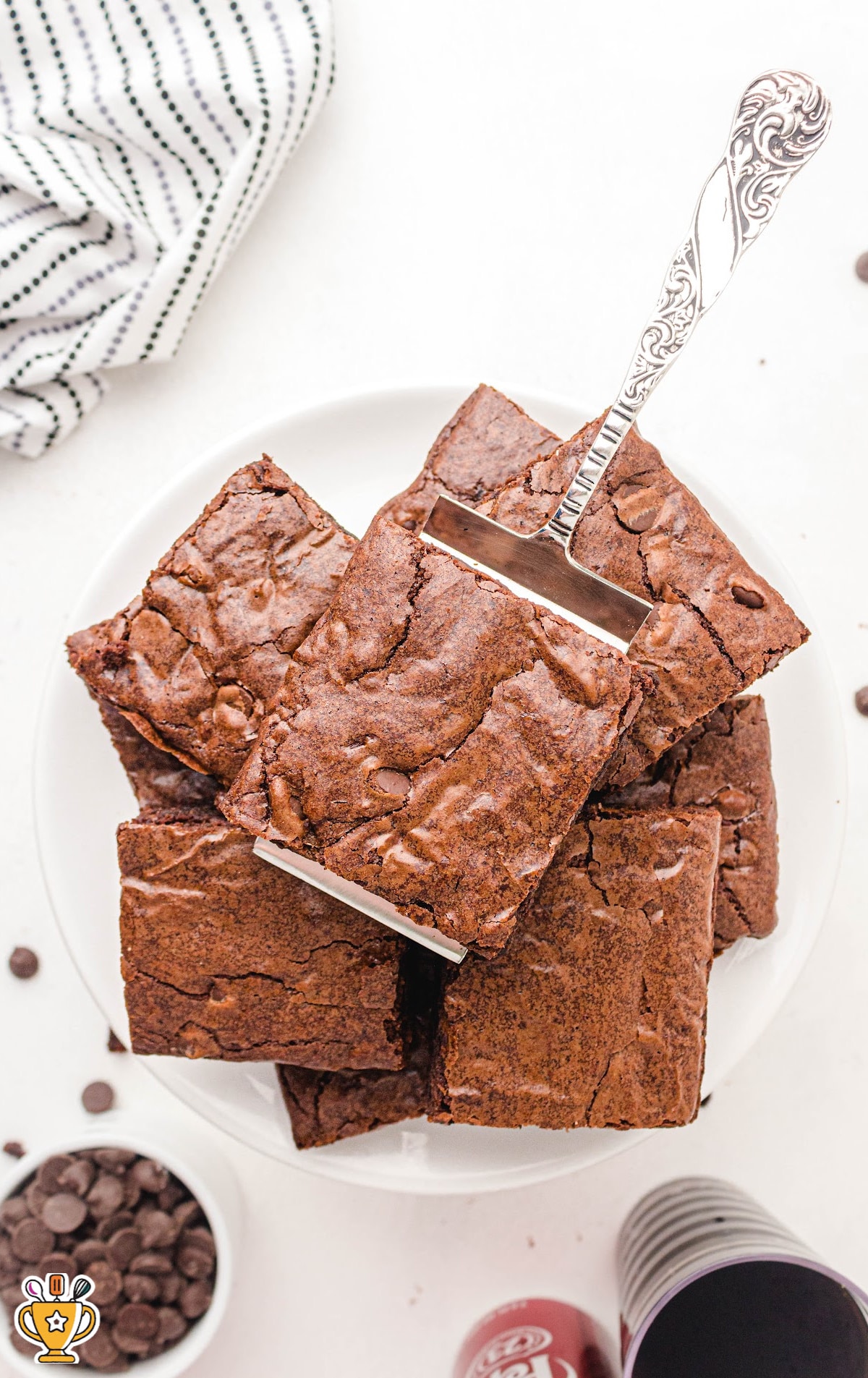 Dr Pepper Brownies on a plate with a spatula holding one