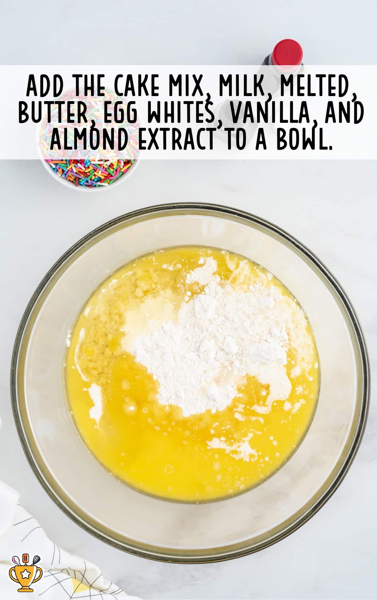 cake mix, milk, melted butter, egg whites, vanilla and almond extract added in a bowl