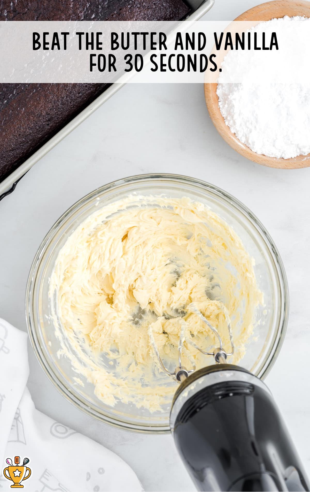 butter and vanilla added in a clear glass bowl and beat by a food mixer