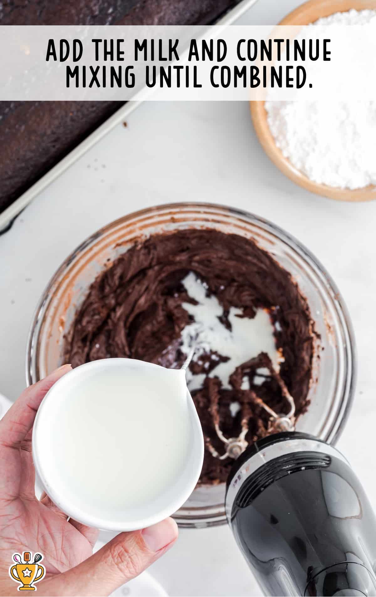 milk added in a bowl full of Hershey Chocolate Cake mixture