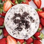 a view of Oreo Dip in a bowl from above, surrounded with strawberries