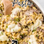 Philly Cheesesteak Pasta in a pan with a wooden spoon