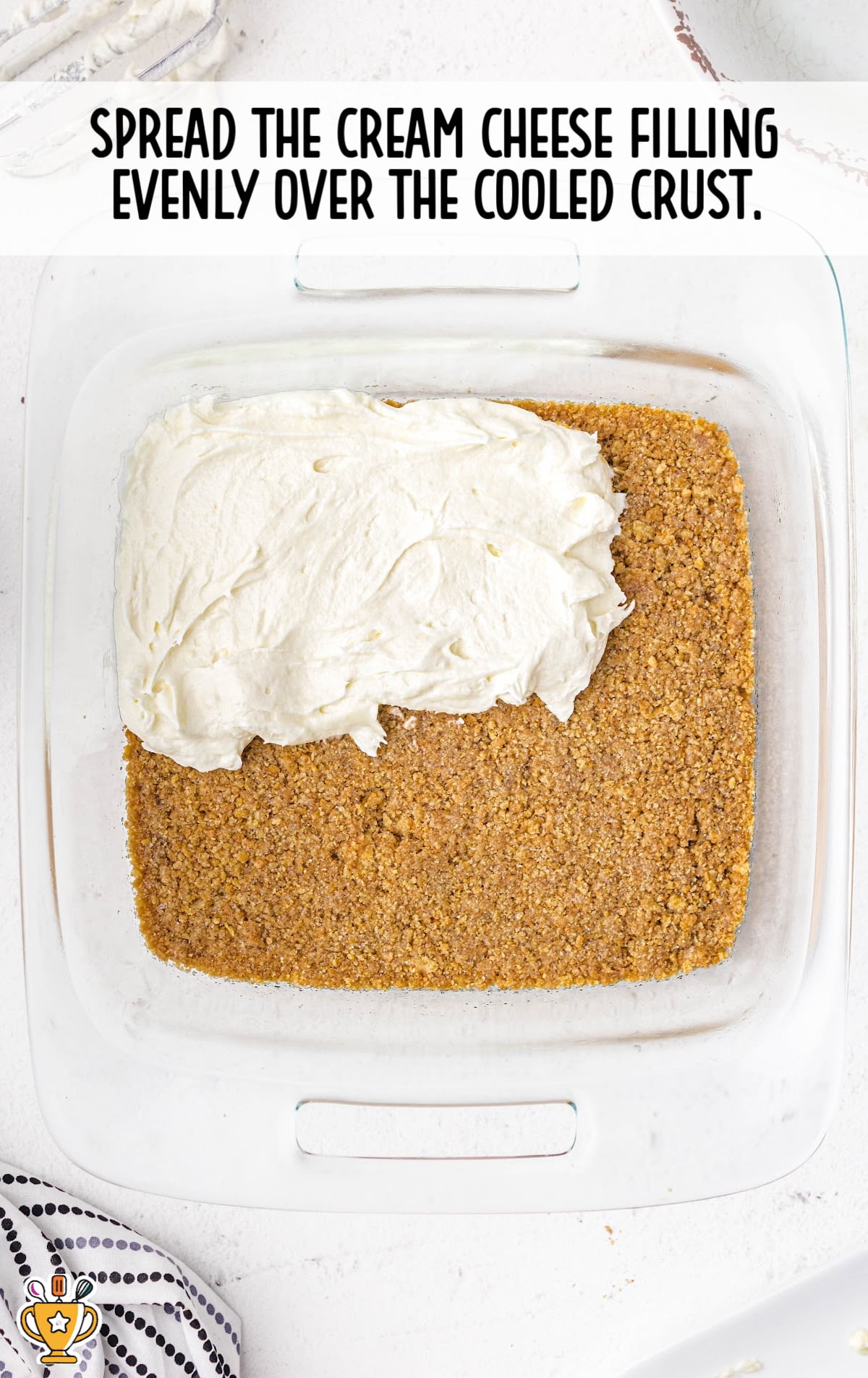 spreading the cream cheese filling over the cooled crust