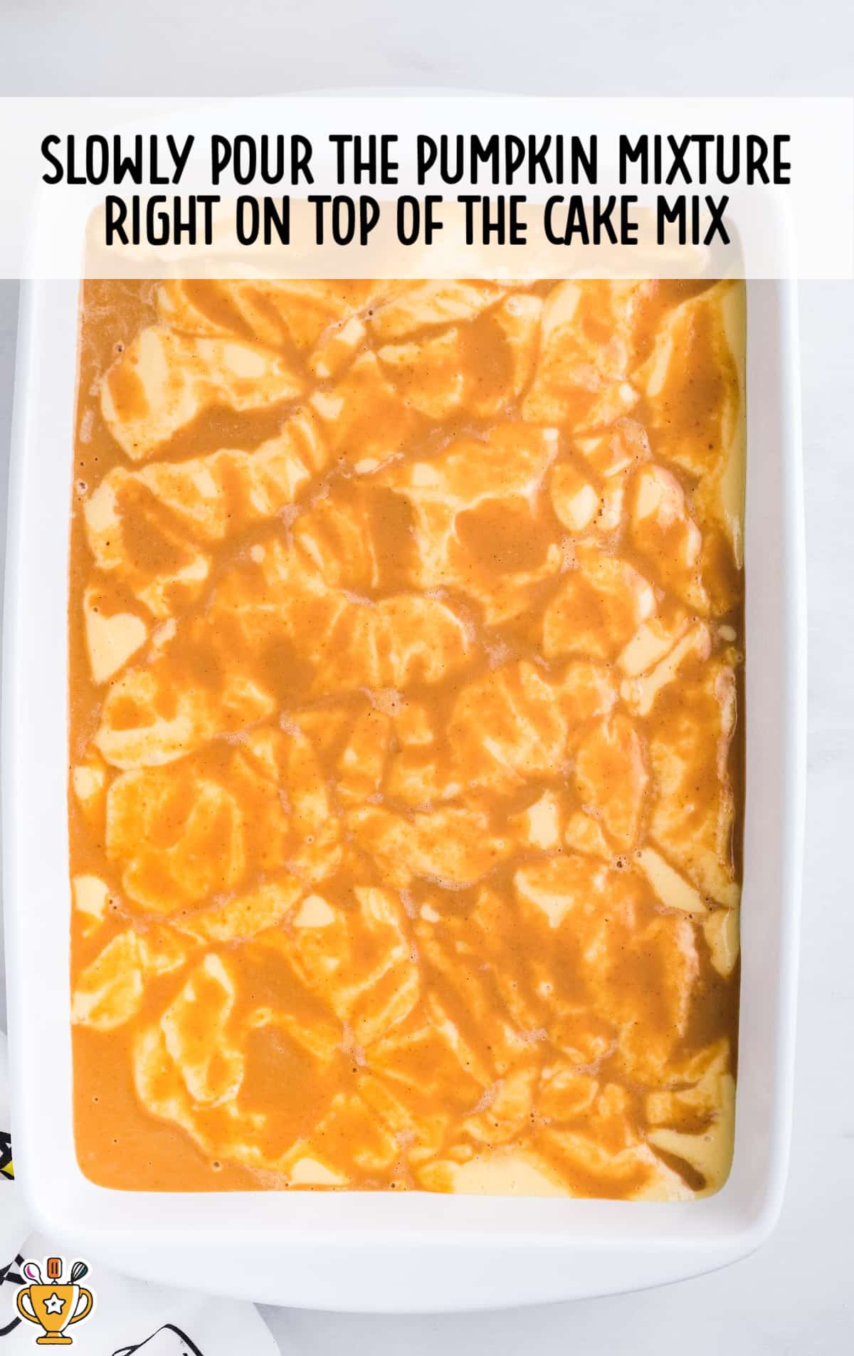 pumpkin pie poured over the cake in a baking dish
